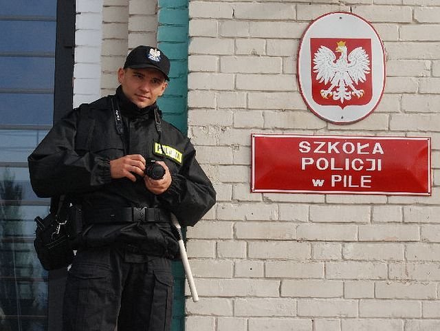 Marcin Bajek przed bramš pilskiej szkoły policyjnej.