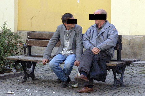 Butelka z winem ukryta w reklamówce. W tle mury świątyni prawosławnej.