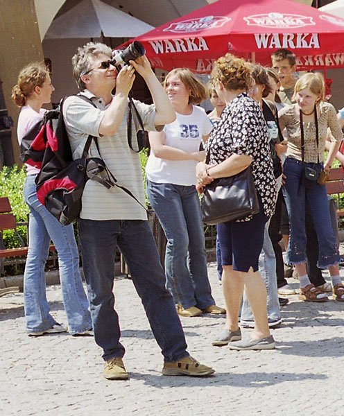 Turysta fotografuje ratusz podczas odtwarzania hejnału.