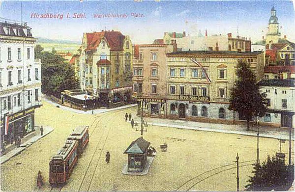 Warmbrunnerplatz z perspektywy okna okolicznych kamienic. Widoczny przystanek tramwajowy z kioskiem i po prawej – budka meteorologiczna.