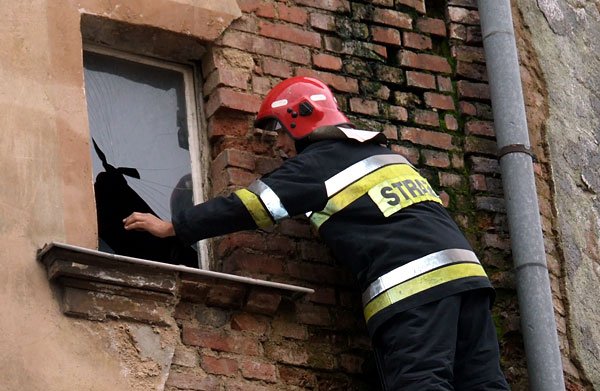 Strażacy nie mogli dostać się do środka. Szybę trzeba było zbić po wejściu na drabinę.